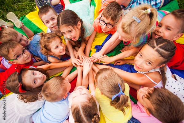 Obraz Top view kids in circle laying on colorful cloth