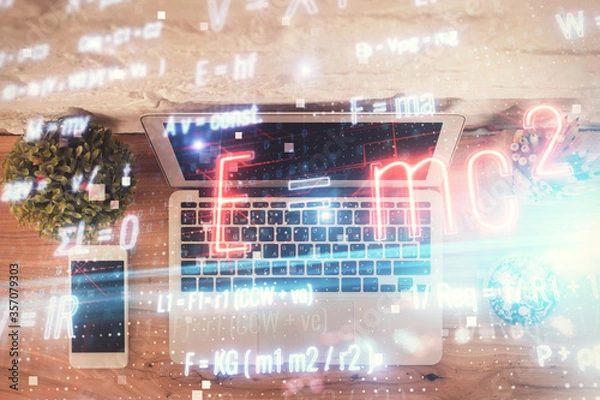 Obraz Physics and math theme hologram with formula drawings over computer on the desktop background. Top view. Multi exposure. Concept of education.