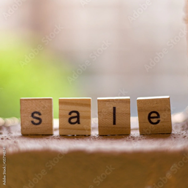 Fototapeta View of block lettering on SALE on stone background. business and shopping concept