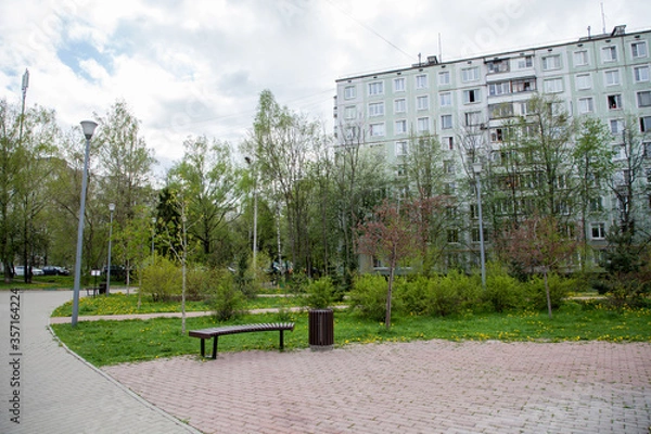 Fototapeta Residential building, bench in the yard