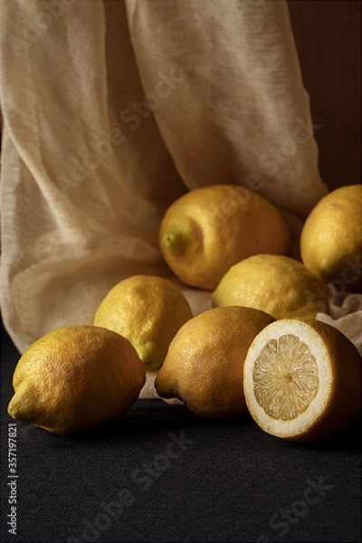Fototapeta still life with lemons in a dark style