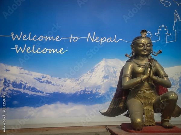 Fototapeta Welcome to Nepall label with a statue of the god Garuda in Kathmandu airport