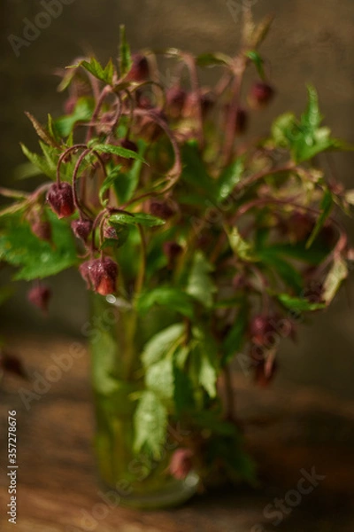 Fototapeta Beautiful photo of wildflowers in a glass with a blurred background.