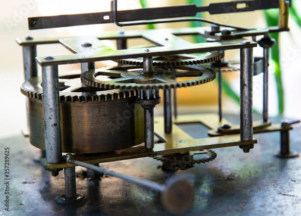 Fototapeta Old and durable wall clock mechanism. mechanisms are just as reliable. close-up.