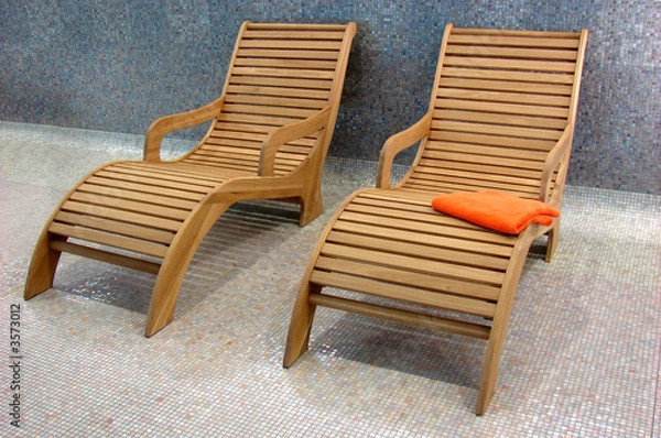 Fototapeta two Sunbeds in the fitness with one orange towel