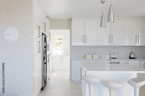 Fototapeta Modern white and clean kitchen interior with stools at counter