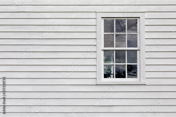Obraz Old Single Pane Window in an Exterior Wall with White Siding