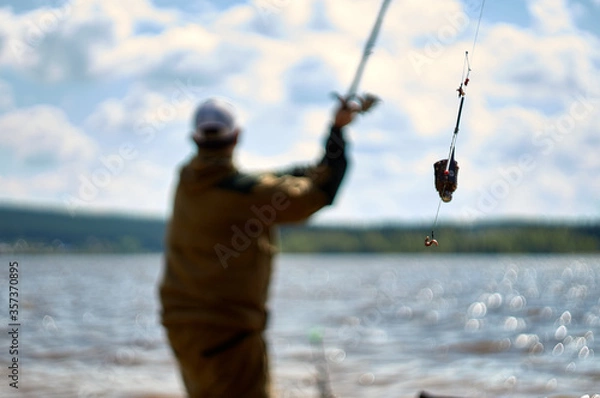 Fototapeta throwing a filled feeder . Closeup of feeder fishing
