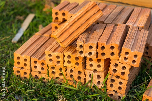 Obraz Red Brick Prepares Construction on Green Grass