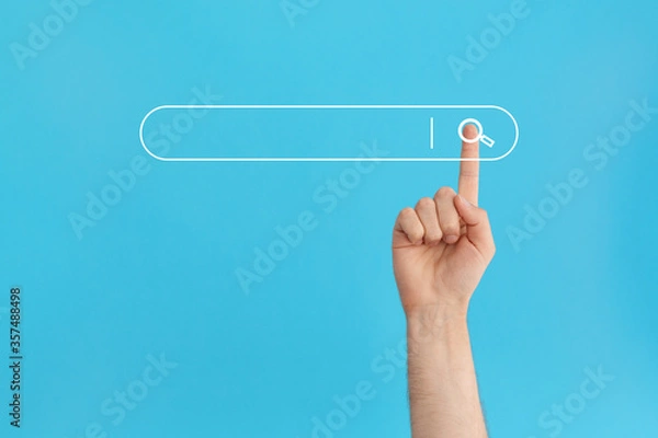 Fototapeta Finger presses the search button in the search bar on a blue background.