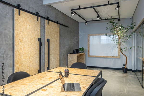 Fototapeta interior design of a office with notebook osb table and sliding doors
