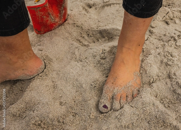Obraz Sandy Feet surrounded by shells on a summers day at the beach