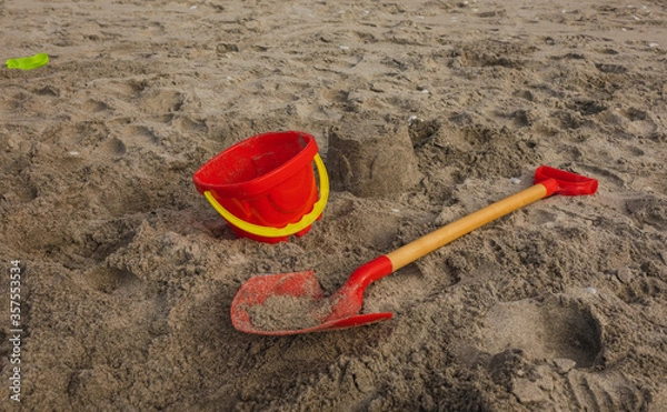 Obraz Summers Day at Beach. Kids made Sandcasle with Spade and Bucket