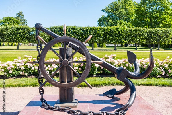 Fototapeta Anchor and steering wheel statue located at the Peterhof gardens, the summer palce of the Peter the great in Saint Petersburg, Russia.