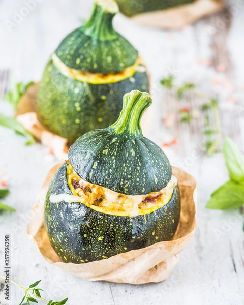 Fototapeta Close up of three stuffed courgettes.
