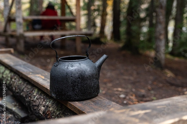 Obraz Kettle with a mug in a tourist camp. outdoor recreation in the forest.