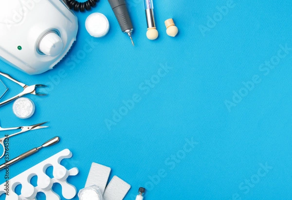 Fototapeta Professional manicure tools on blue background..