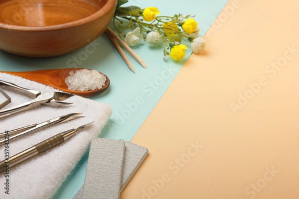 Fototapeta Professional manicure tools on blue and beige background..