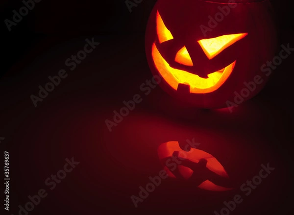 Fototapeta Glowing pumpkin with a candle inside