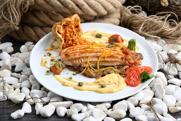 Obraz Grilled salmon with vegetables served.