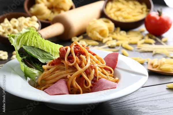 Fototapeta Delicious spaghetti served on a white plate.