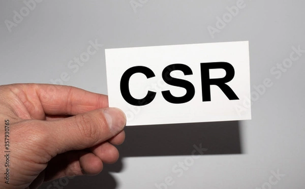 Fototapeta Message on the card CSR, in hands of businessman.