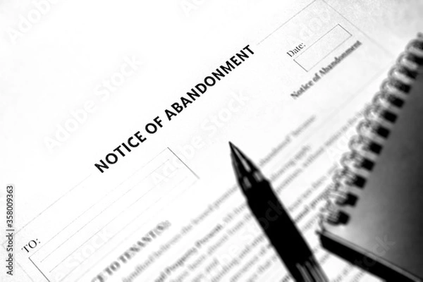 Fototapeta The notice of abandonment document. Document old style black and white. Paper and pen on the table.