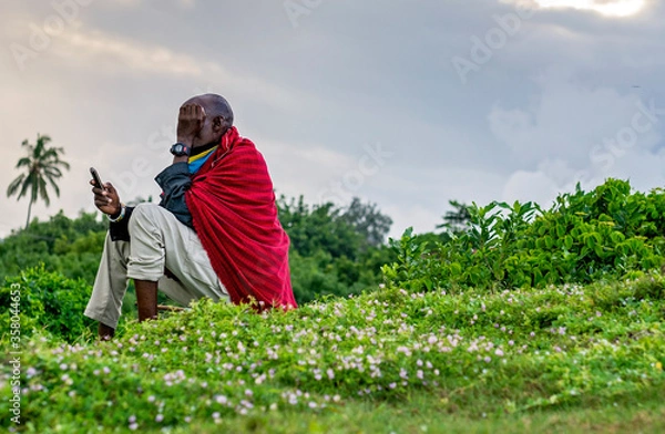 Obraz Maasai man using a mobile phone