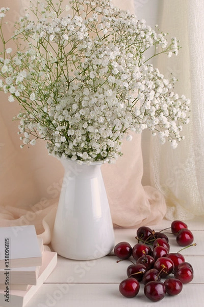 Fototapeta decorated with a simple bouquet of flowers and cherries