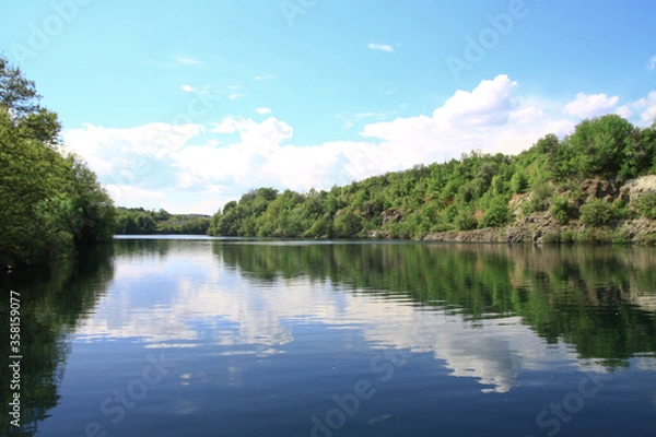 Fototapeta Beautiful river in the highlands in summer. Lake in an ecologically clean park reserve on a background of hills. A pretty landscape in the spring. Stock photo for design