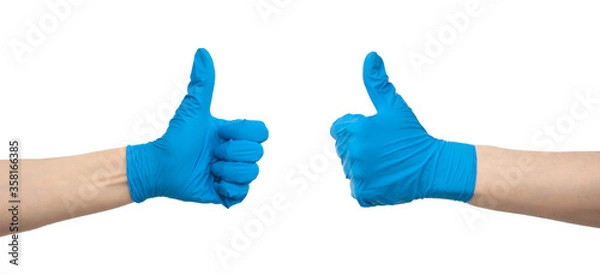 Fototapeta Doctor hands in blue medical gloves showing like gesture or thumb up. Approval, accept or done concept. Isolated on white background. Thanks to medical workers concept