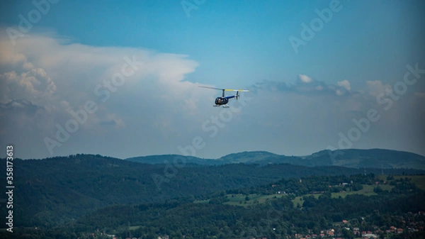 Fototapeta Robinson 44 Raven II helicopter at flight over Karkonosze mountains in Poland