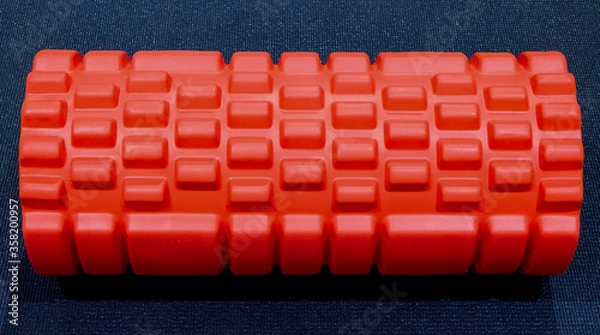 Fototapeta Close-up view of a foam roller on a yoga mat