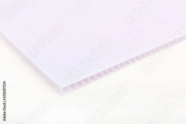 Obraz Polycarbonate plastic sheets panels images. PC hollow sheet for translucent roofing close up. Single white color on white background