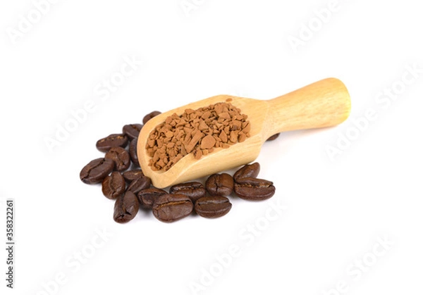 Obraz freeze dried instant coffee in wooden spoon and roasted coffee beans on white background