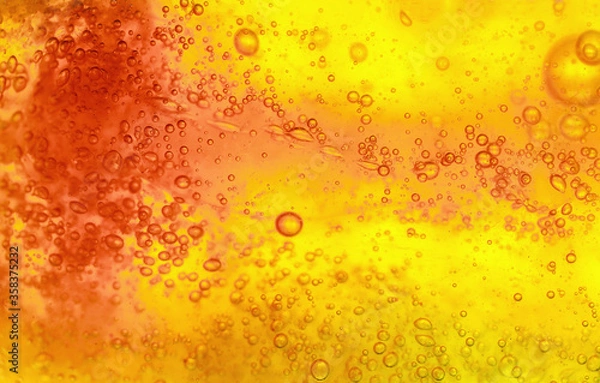 Obraz Abstract textured gel background. Yellow and orange liquid with bubbles.