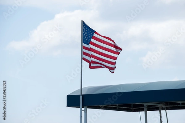 Fototapeta American flag waving in the air at Hawaii pear harbor Arizona memorial on the fourth of July 