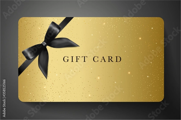 Fototapeta Gift card with twinkling stars, sparkling elements and bow (ribbon) on gold background. Golden template useful for any design, shopping card, voucher or gift coupon