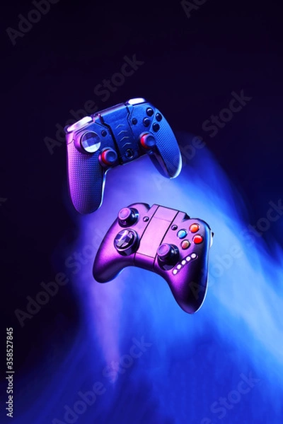 Fototapeta Levitation of two controller joysticks.