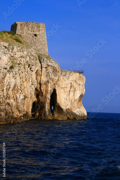 Fototapeta Ancient tower standing on a seaside cliff