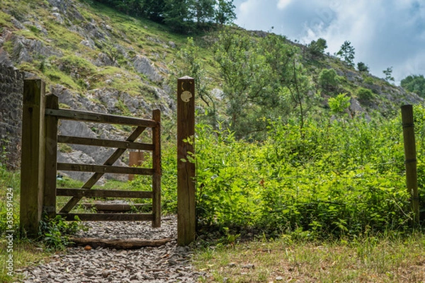 Fototapeta Footpath entrance gate near Rock of Ages at the Cheddar Gorge.  Cliffs seen in the background.