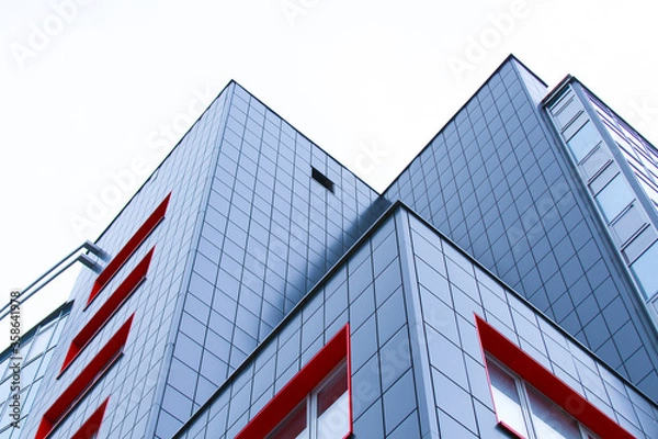 Obraz Corners of buildings with many windows against a white sky. The concept of a modern office building