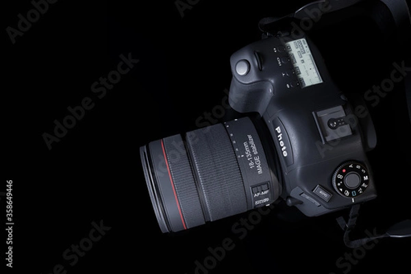 Fototapeta Top view professional digital camera with a zoom lens and a leather strap on a black background with copy space. View from above. Realistic 3d render. Place for advertising text. Reflection at bottom