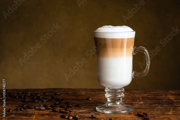 Obraz Cafe latte macchiato layered coffee in a see through glass irish coffee glass