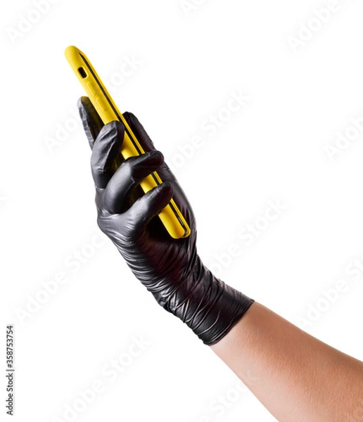 Fototapeta Hand in black glove holding mobile phone with blank screen isolated on white
