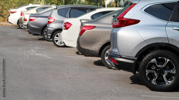 Fototapeta Closeup of rear, back side of blue car with other cars parking in outdoor parking area in bright sunny day. 