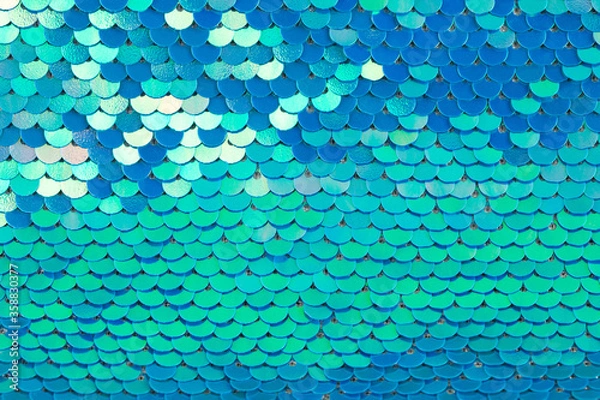Fototapeta Abstract textured holographic background from turquoise shiny iridescent sequins, like mermaid or fish scales. Trendy texture with copy space. Celebration, holidays, fashion concept. Horizontal