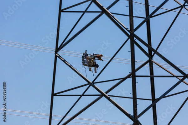 Obraz Line workers installing spacer dampers on high voltage power conductors.  Several scenes shot at each location to capture this detailed task.