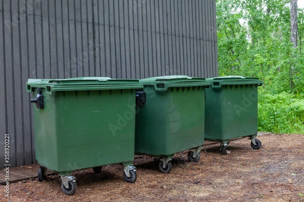 Fototapeta Plastic garbage containers on the street