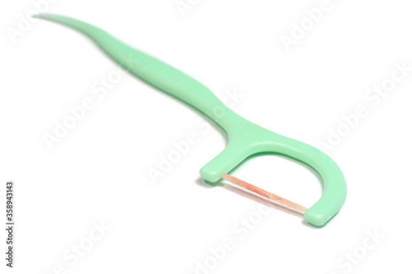 Fototapeta Toothpick and dental floss already used with blood form bleeding gums isolated on white background.